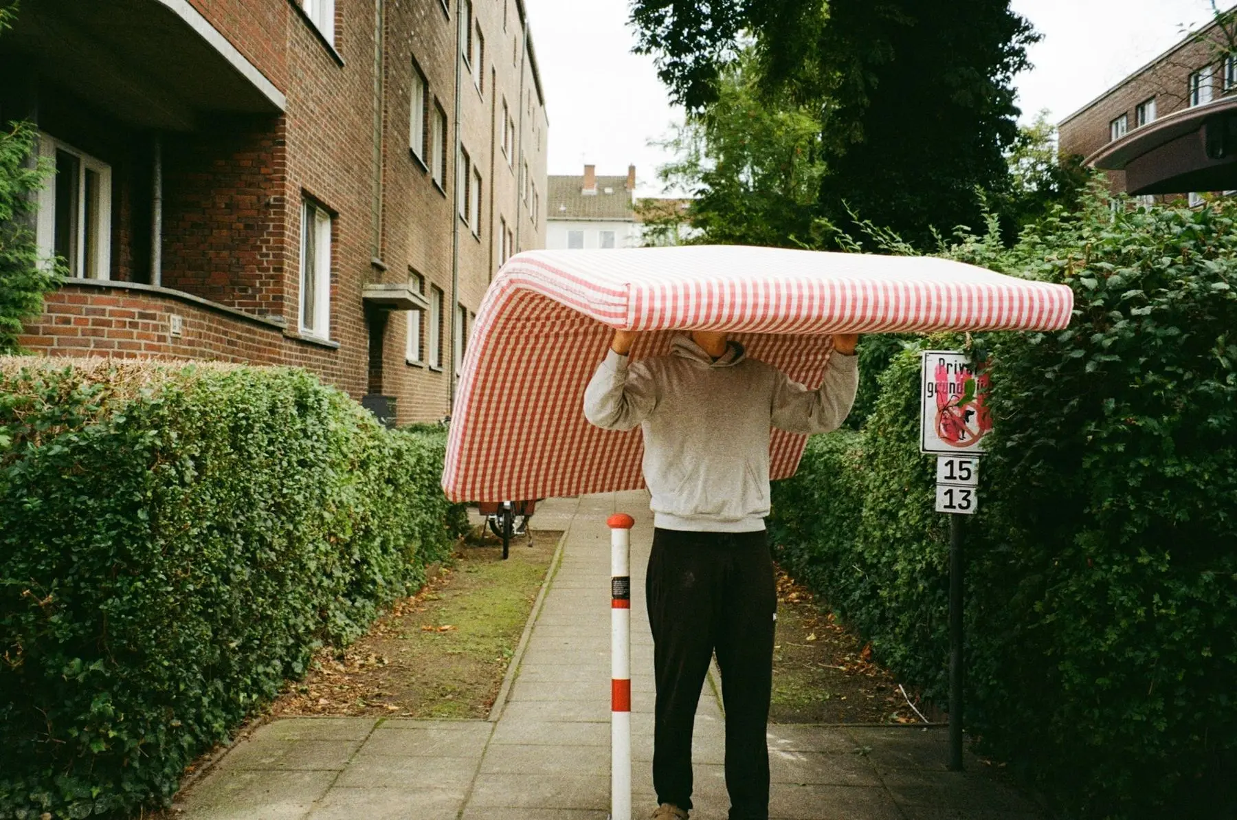 A man carrying a mattress
